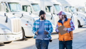 transportation fleet of trucks with drivers talking